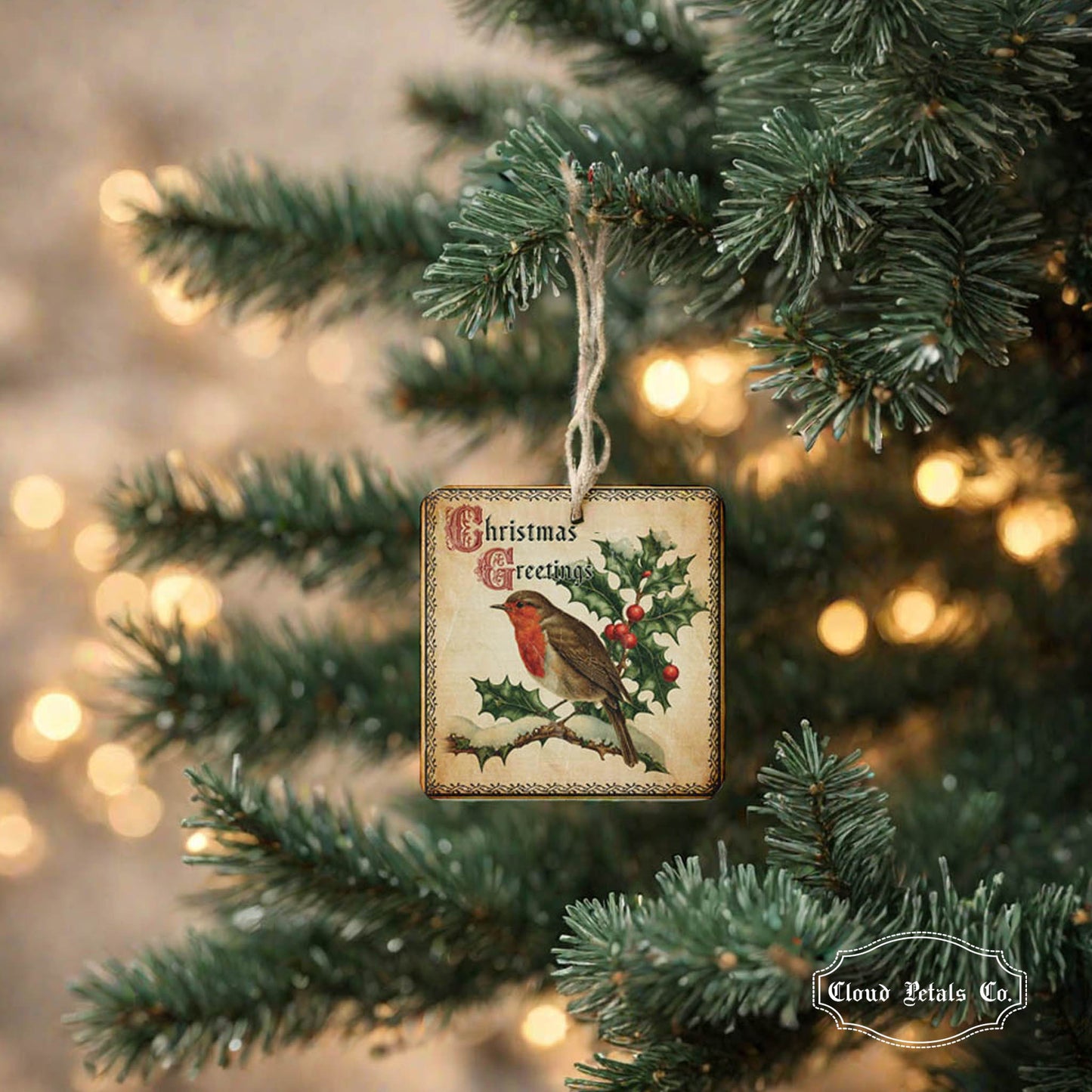 Christmas ornament with robin and holly on a tree