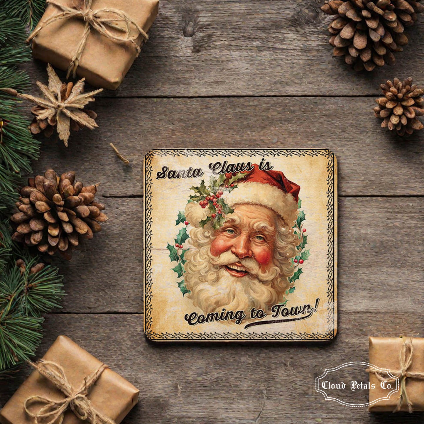Decorative Santa Claus sign on a wooden background with pinecones and gifts.