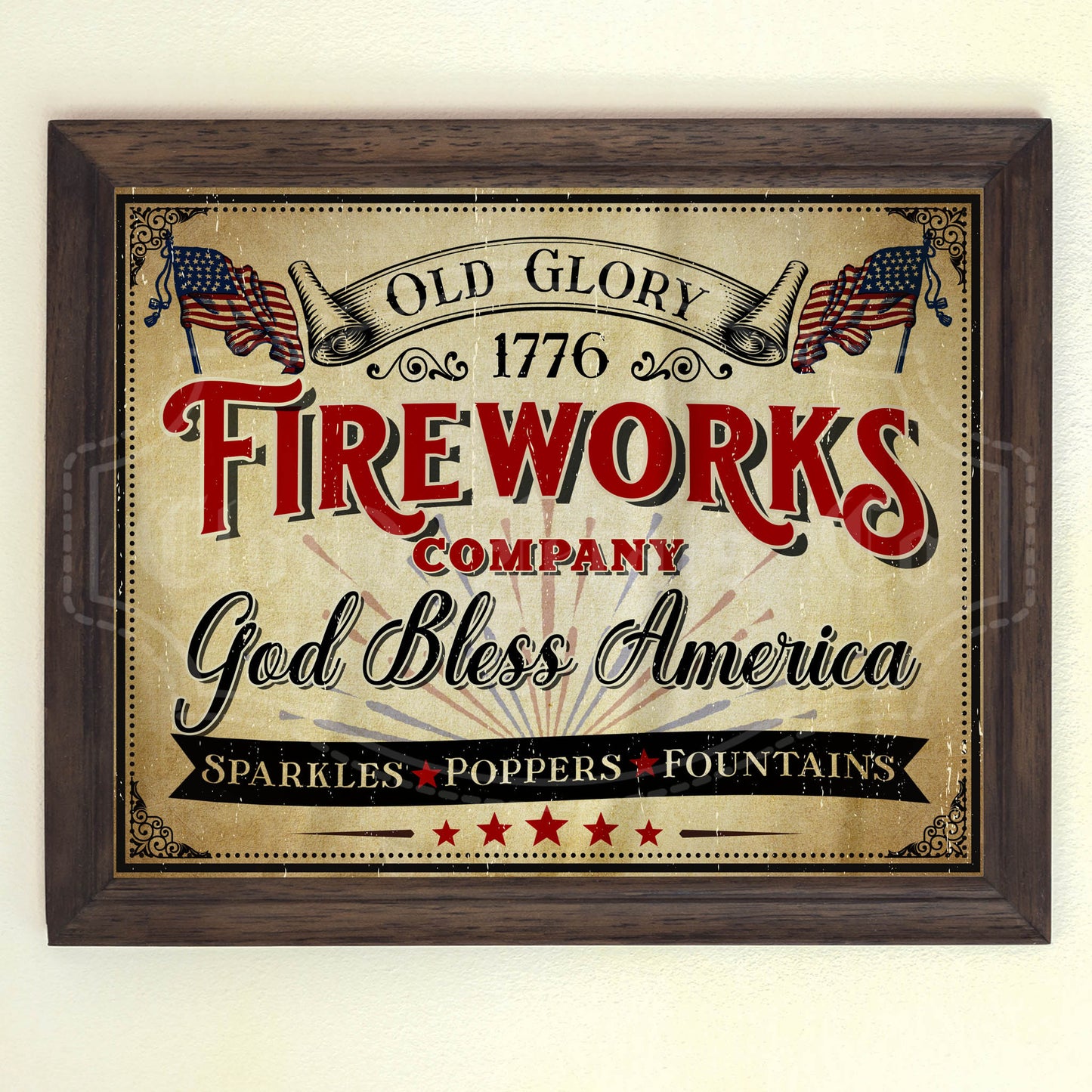 A vintage style 4th of July fireworks sign with the text 'Old Glory 1776 FIREWORKS COMPANY God Bless America' and American flags, sparkles, and fountains mentioned below. The sign is presented in a wooden frame.