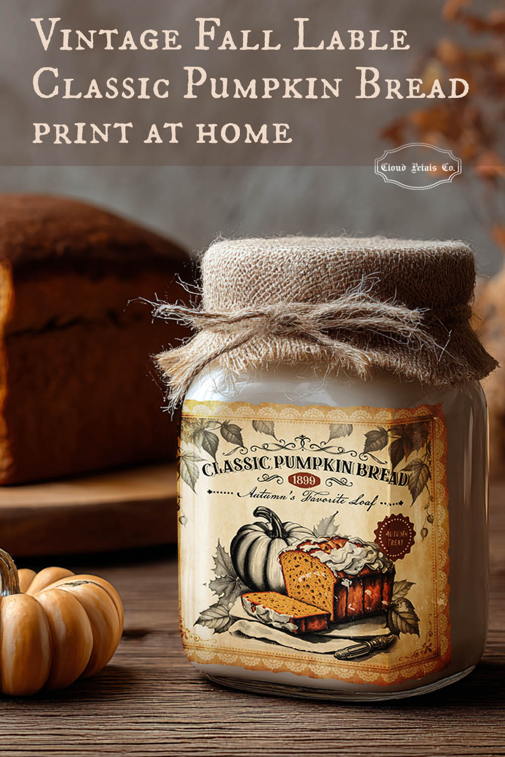 Jar with a vintage-style pumpkin bread label on a wooden surface with pumpkins and bread in the background.
