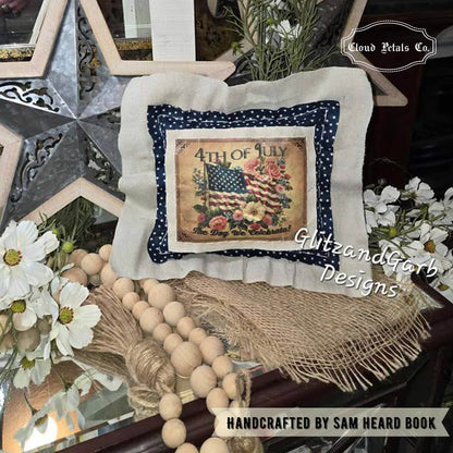 Decorative pillow with American flag design on a table with flowers and beads
