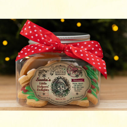 Jar with vintage-style Christmas label and red polka dot ribbon on a wooden surface with blurred lights in the background.