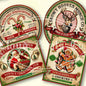 Four Christmas-themed product packaging designs with festive graphics and text.