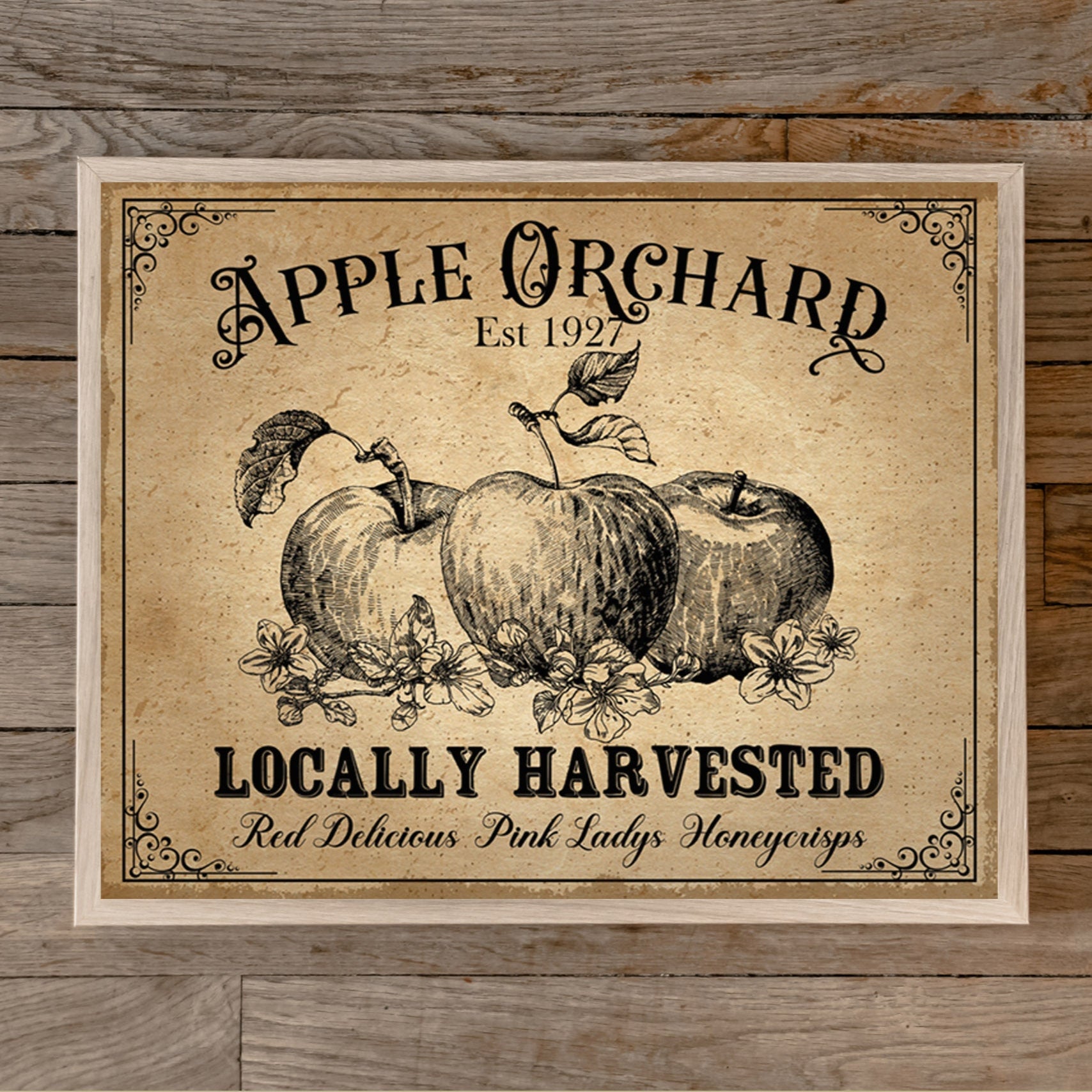 Vintage-style 'Apple Orchard' decor sign on a wooden background with text about size and brand.